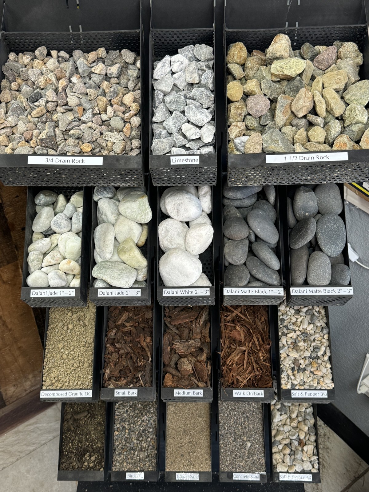 Sample bins of drain rock, limestone, river cobble, decomposed granite, bark mulch and sand available for delivery in South Lake Tahoe